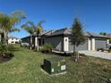 House exterior showcasing landscaping and driveway at 15511 Sunny Day Dr, Lakewood Ranch, FL 34211