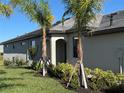 Side view of the house showing an entrance and landscaping at 15511 Sunny Day Dr, Lakewood Ranch, FL 34211