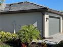 Gray house exterior with garage and landscaping at 15511 Sunny Day Dr, Lakewood Ranch, FL 34211