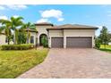 Beautiful home with a three-car garage and well-manicured landscaping at 17802 Eastbrook Ter, Lakewood Ranch, FL 34202
