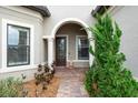Charming front entrance with a decorative door and lush greenery at 17802 Eastbrook Ter, Lakewood Ranch, FL 34202