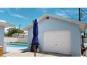 View of a garage and refreshing blue swimming pool at 20439 Peachland Blvd, Port Charlotte, FL 33954