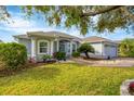 Gray one-story house with lush lawn, palm tree, and driveway at 3226 44Th E Dr, Bradenton, FL 34203