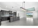 Modern kitchen with granite countertops, gray cabinets and tile floors at 4704 Foxtail Dr, Parrish, FL 34219