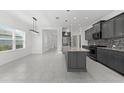 Modern kitchen with granite countertops, gray cabinets, and tile flooring at 4704 Foxtail Dr, Parrish, FL 34219