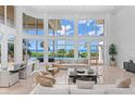 Living room with expansive ocean views and pool access at 5919 Gulf Of Mexico Dr, Longboat Key, FL 34228
