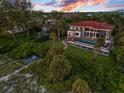Stunning aerial view of a home with a pool overlooking the ocean at 5919 Gulf Of Mexico Dr, Longboat Key, FL 34228