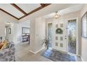 Bright entryway with tile flooring, exposed beams, and view to living room at 105 Hourglass Dr, Venice, FL 34293