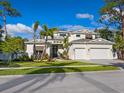 Two-story house with white siding, three-car garage, and landscaped front yard at 1516 S Orange Ave, Sarasota, FL 34239