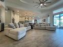 Spacious living room featuring tile floors, ceiling fan, recessed lighting, and modern decor at 15618 Castle Park Ter, Lakewood Ranch, FL 34202