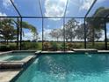 Sparkling swimming pool with a spa inside of a screened-in enclosure, offering serene views at 15618 Castle Park Ter, Lakewood Ranch, FL 34202