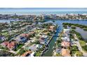Stunning aerial view of waterfront home, pool, lush landscaping, and canal access to Gulf of Mexico at 1649 Stanford Ln, Sarasota, FL 34231