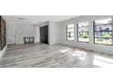 Bright, airy living room with wood floors, modern black trim windows and entry door at 1649 Stanford Ln, Sarasota, FL 34231