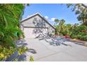 Gray house with a two-car garage and mature trees at 1775 Southwood St, Sarasota, FL 34231