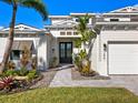 Front entry of a two-story house with white siding at 1827 Morris St, Sarasota, FL 34239