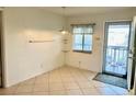 Small dining area with tile floors and access to a balcony at 3751 S School Ave # 29, Sarasota, FL 34239