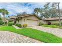 Charming single-story home with a two-car garage and a beautifully landscaped front yard at 5669 Pipers Waite # 38, Sarasota, FL 34235