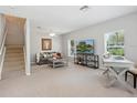 Bright living room featuring neutral tones, a comfortable seating area, and a staircase at 6205 Triple Tail Ct # 101, Lakewood Ranch, FL 34202