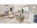 Bright and airy living room featuring tile flooring, modern furnishings and plenty of natural light at 6352 Coniston Ter, North Port, FL 34287