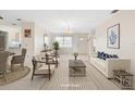 Bright living room boasts tile floors, neutral tones, and comfortable seating arrangements at 6352 Coniston Ter, North Port, FL 34287