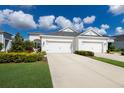 Two-story house with a three-car garage and well-manicured landscaping at 14538 Barefoot Ln, Parrish, FL 34219
