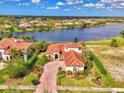 Luxury home on the lake with beautiful landscaping at 1509 Raphis Royale Blvd, Englewood, FL 34223