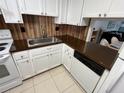 White kitchen with dark brown countertops at 1540 Glen Oaks E Dr # B336, Sarasota, FL 34232