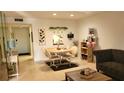 A well-lit living room with a round dining table and tile floors at 1540 Glen Oaks E Dr # B336, Sarasota, FL 34232
