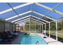 Inviting screened pool with lounge chairs and a dolphin toy at 25250 Paraguay St, Punta Gorda, FL 33983