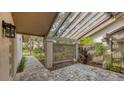 Covered patio with brick pavers and latticework creating a relaxing outdoor space at 3124 Sandleheath # 80, Sarasota, FL 34235