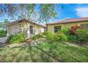 Exterior view of condo with lush landscaping at 4573 Pine Green Trl # 1, Sarasota, FL 34241