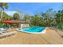 Community pool with lounge chairs and patio area at 4573 Pine Green Trl # 1, Sarasota, FL 34241
