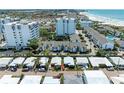 Aerial view showing property's location near beach and other buildings at 1048 W Peppertree Ln # 118B, Sarasota, FL 34242