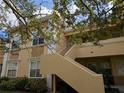 Condo building exterior with stairs and landscaping at 1185 Villagio Cir # 207, Sarasota, FL 34237