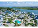 Aerial view of waterfront community with pool and lush landscaping at 1328 Siesta Bayside Dr # 1328-C, Sarasota, FL 34242