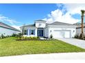 Single-story home with gray roof, blue shutters, and landscaped yard at 15625 San Lazzaro Ave, Bradenton, FL 34211