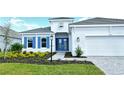 Two-story home with gray roof, white walls, and blue shutters at 15625 San Lazzaro Ave, Bradenton, FL 34211