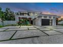 Stunning modern home featuring a well-manicured lawn, unique concrete driveway, and ample parking at 2038 Datura St, Sarasota, FL 34239