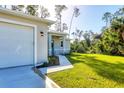 New construction home with a modern garage and walkway at 2814 Daphne Rd, North Port, FL 34288