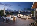 Enjoy evenings on this spacious outdoor patio with dining, seating, and a stunning ocean view at 3200 Higel Ave, Sarasota, FL 34242