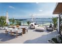 Enjoy panoramic water views from this roof deck with dining, lounging, and a fire pit at 3200 Higel Ave, Sarasota, FL 34242