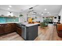 Modern kitchen featuring quartz countertops, stainless steel appliances, and an open layout to the living area at 3700 S Osprey Ave # 214, Sarasota, FL 34239