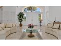 Bright and spacious living room with high ceilings and comfortable seating at 5331 Siesta Cove Dr, Sarasota, FL 34242