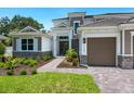 Two-story home with a three-car garage, stone accents, and a walkway at 1637 Hyde Park St, Sarasota, FL 34239