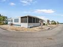 Mobile home with screened porch and landscaped yard at 2107 Palma Sola Blvd # 94, Bradenton, FL 34209