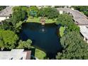 Aerial view of condo community featuring a serene lake and lush greenery at 315 30Th W Ave # B311, Bradenton, FL 34205