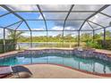 Inviting screened pool and spa with a picturesque lake view at 335 River Enclave Ct, Bradenton, FL 34212