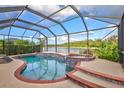 Relaxing screened pool and spa with a beautiful lake view at 335 River Enclave Ct, Bradenton, FL 34212