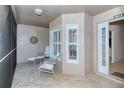 Cozy screened porch with seating and view of the entrance at 5370 Hyland Hills Ave # 2726, Sarasota, FL 34241