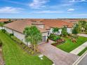 Single-Gathering home with landscaping and a brick driveway at 5460 Lampiasi St, Sarasota, FL 34238